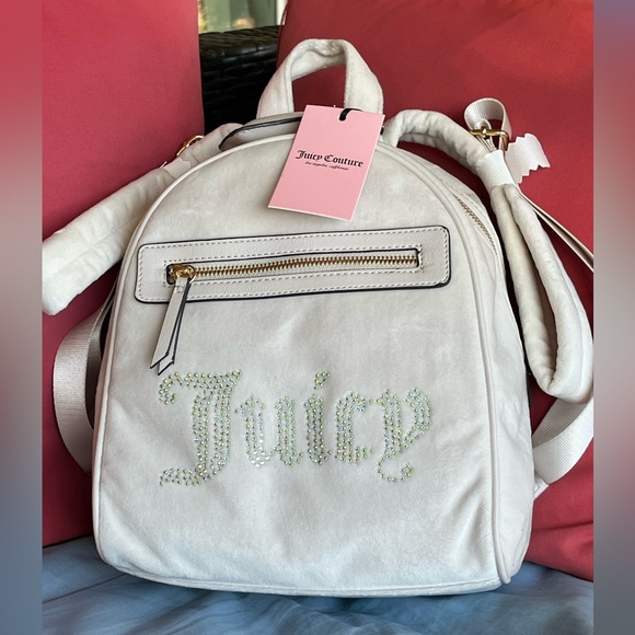 Juicy Couture Handbags - Juicy Couture velvet backpack. Ivory w/rhinestone logo. Ivory. NWT. Great gift.